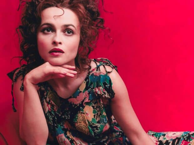 Helena Bonham Carter wears a colorful dress and poses thoughtfully against a bright red backdrop, HD Desktop Wallpaper