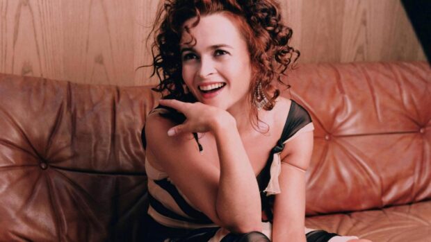 Helena Bonham Carter is sitting on a leather couch smiling brightly, HD Desktop Wallpaper