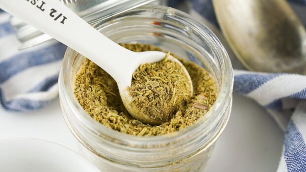 A close up of seasoning with a white spoon in a glass jar on a kitchen cloth, HD Desktop Wallpaper