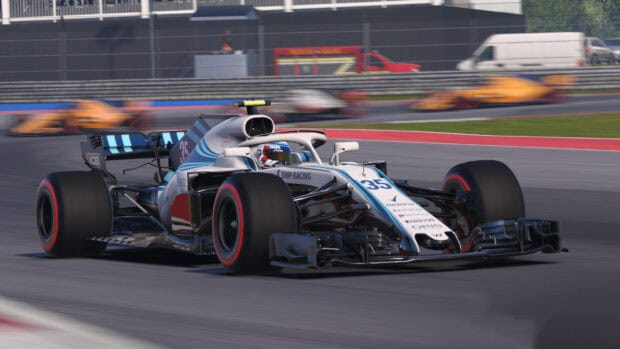An F1 race car is speeding on a racing circuit with blurred background, 4K Desktop Wallpaper