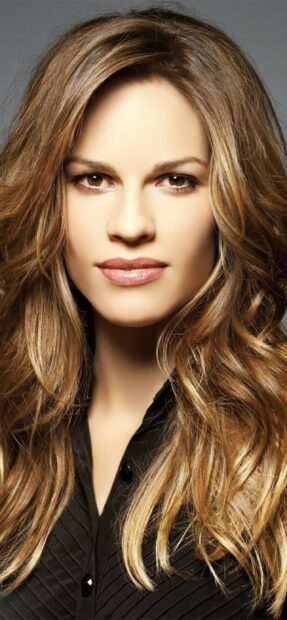 A close up portrait of Hilary Swank with wavy hair and natural makeup, 2K Phone Wallpaper