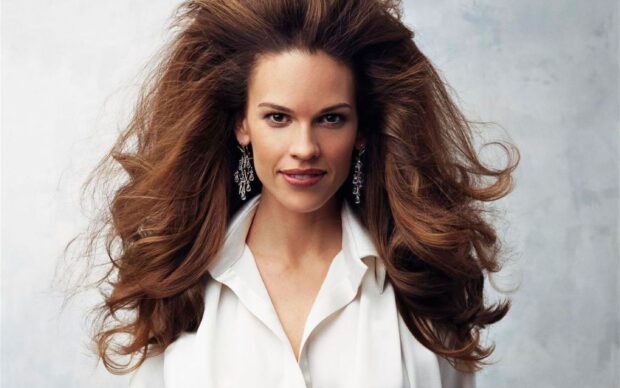 Hilary Swank wallpapers showing her in a white blouse and statement earrings, 2K Desktop Wallpaper