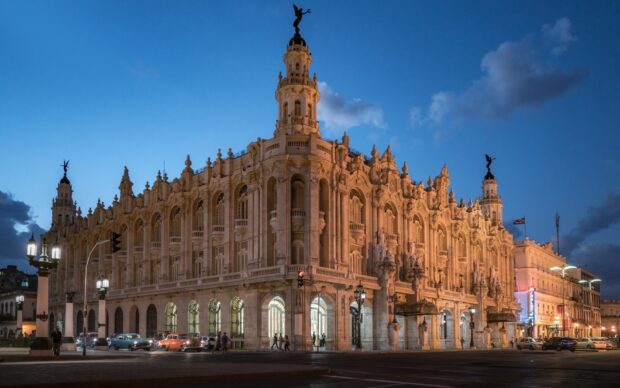 The grand colonial building in Havana Cuba glows warmly under the evening sky, HD Desktop Wallpaper