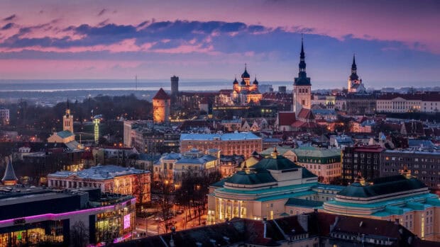 The Estonia Wallpapers show a vibrant city under a colorful sky, HD Desktop Wallpaper