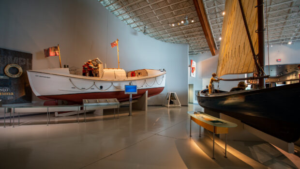 Exhibits of historic boats at the maritime museum with detailed displays, 2K Desktop Wallpaper