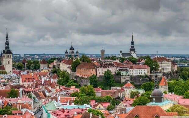 The Estonia cityscape shows historic buildings and towers under a cloudy sky, 2K Desktop Wallpaper