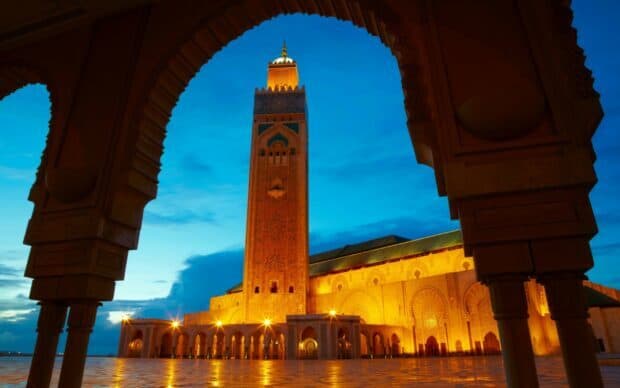 A historic mosque tower is beautifully illuminated under the twilight sky in Morocco Wallpapers, HD Desktop Wallpaper