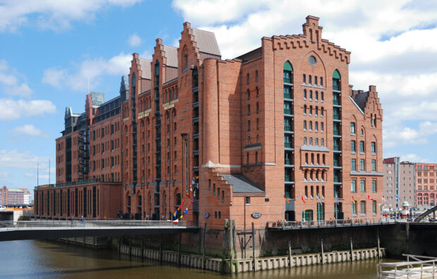 The Maritime Museum stands tall with red brick walls near the river under a blue sky, HD Desktop Wallpaper