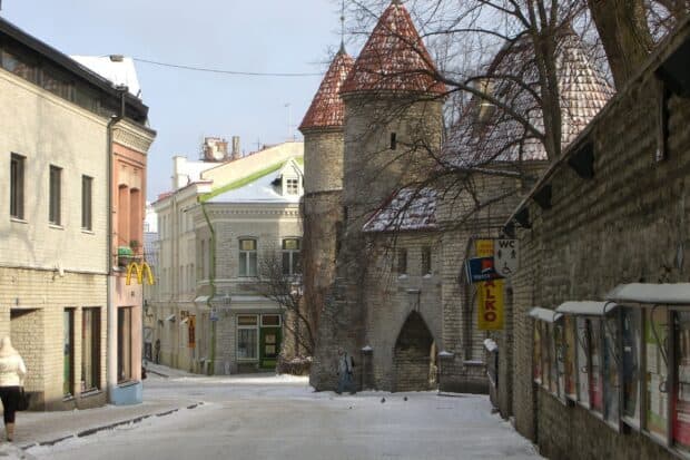 A snowy street with historic towers and buildings in Estonia is shown in this Estonia wallpapers, 2K Desktop Wallpaper