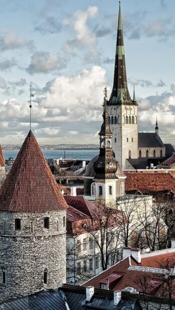 Estonia showcases its historic towers and rooftops against a cloudy sky, HD Mobile Wallpaper