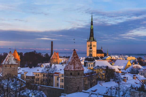 The snow covered old town is beautifully lit by the evening sun showcasing Estonia Wallpapers, 2K Desktop Wallpaper