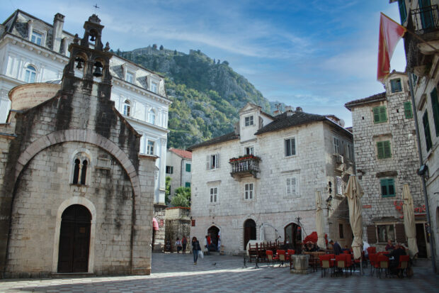 The historic town square in Montenegro Wallpapers shows old stone buildings and a mountain backdrop, HD Desktop Wallpaper