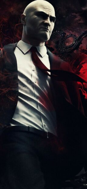 A serious Hitman Game character stands in a shadowy environment with a red tie, HD Mobile Wallpaper