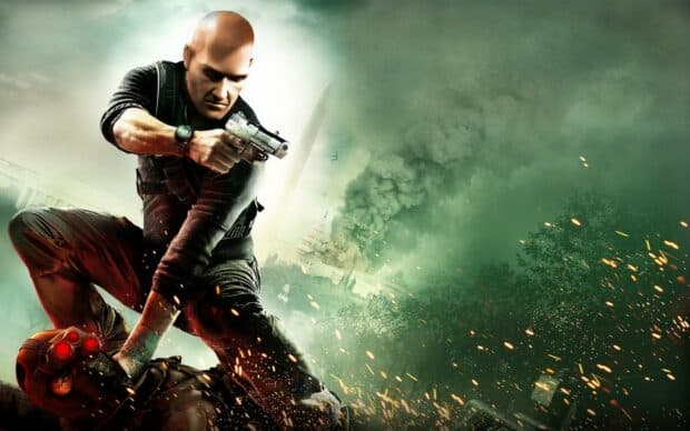 A hitman aims a gun during a fierce battle with explosions and smoke in the background, HD Desktop Wallpaper