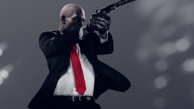 A hitman character is aiming a pistol in a dark suit with a red tie, HD Desktop Wallpaper