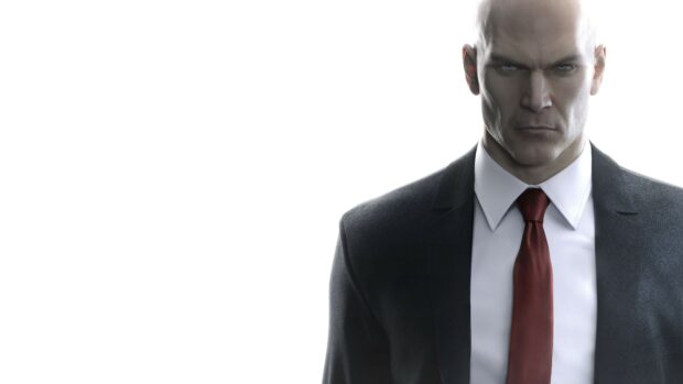 The Hitman character in a suit and red tie looks intensely at the viewer, 4K Desktop Wallpaper
