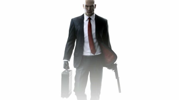 The Hitman character stands confidently holding a briefcase and a gun in a dark suit and red tie, 4K Desktop Wallpaper