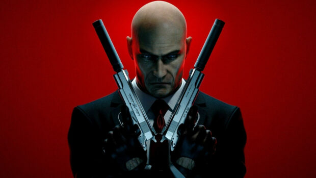The Hitman character holds two silenced pistols against a red background with intense focus, HD Desktop Wallpaper