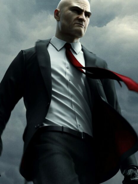 A determined Hitman game character stands under a cloudy sky wearing a black suit with a red tie, HD Mobile Wallpaper