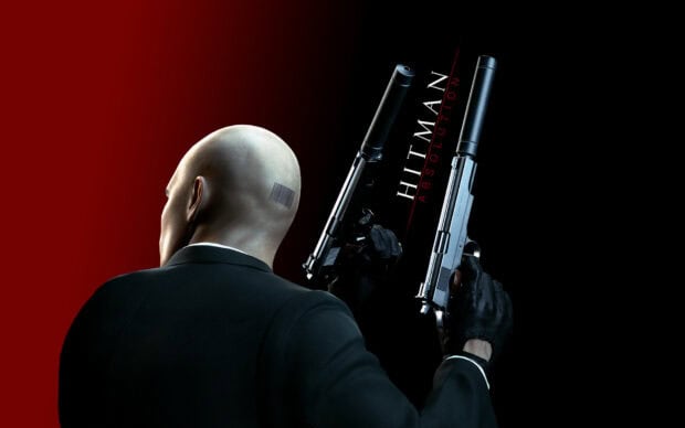 A Hitman character is shown holding dual pistols against a red and black background, HD Desktop Wallpaper