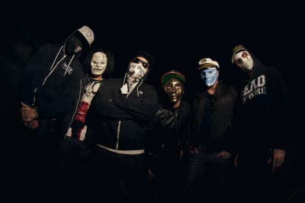 Hollywood Undead band members wear diverse masks in a dark setting, HD Desktop Wallpaper