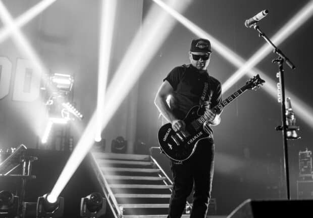 A member of Hollywood Undead band plays guitar on stage during a concert, 2K Desktop Wallpaper