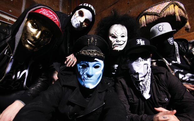 The Hollywood Undead band is pictured wearing unique masks and dark clothing indoors, 2K Desktop Wallpaper