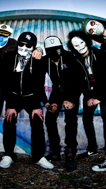 The Hollywood Undead band members pose together wearing distinctive masks in an outdoor setting, HD Phone Wallpaper