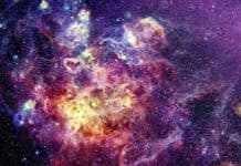 A holographic wallpapers showing a vibrant cosmic nebula with stars and glowing gas clouds, HD Desktop Wallpaper