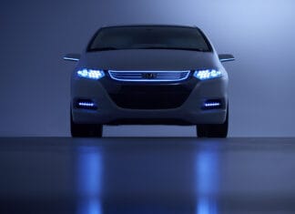 A Honda Insight is shown from the front with illuminated blue headlights and reflective surface, 2K Desktop Wallpaper