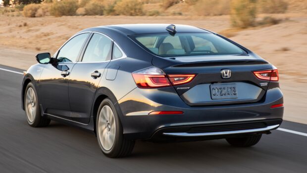 A sleek Honda Insight is shown driving on a desert highway, 4K Desktop Wallpaper