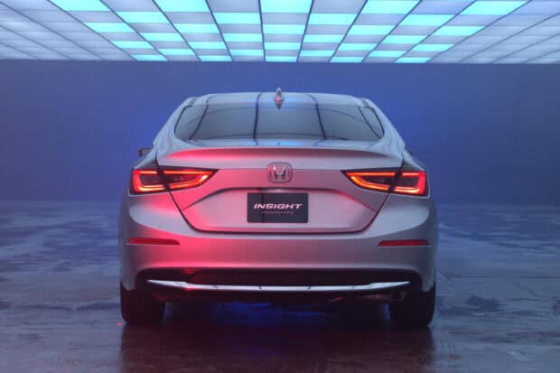 The Honda Insight showcases its sleek rear design with illuminated taillights in a studio setting, 2K Desktop Wallpaper