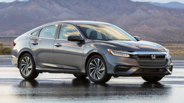 A gray Honda Insight is parked on a wet surface with mountains in the background, HD Desktop Wallpaper