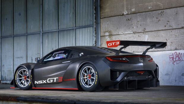 The Honda NSX GT3 racing car is captured in an industrial setting with detailed carbon fiber bodywork, 4K Desktop Wallpaper