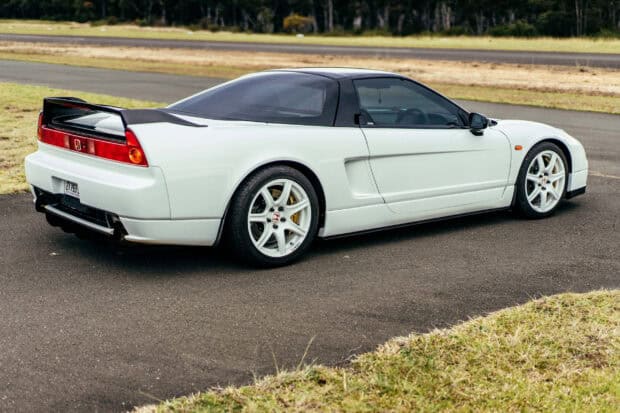A white Honda NSX sports car is parked on an asphalt road with grass and trees in the background, 2K Desktop Wallpaper