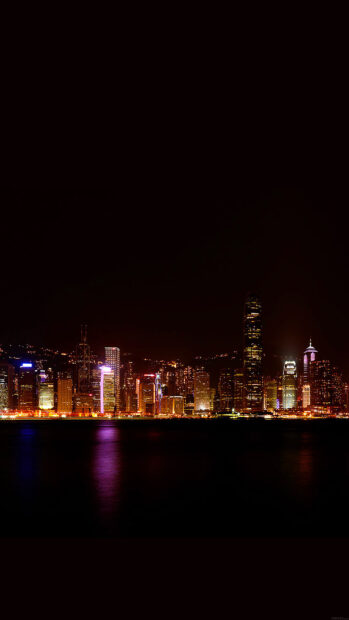 The Hong Kong skyline shows illuminated skyscrapers reflecting on water at night, HD Phone Wallpaper