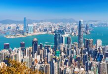 A clear view of Hong Kong skyline with skyscrapers and mountains in the background, 2K Desktop Wallpaper