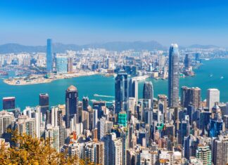 A clear view of Hong Kong skyline with skyscrapers and mountains in the background, 2K Desktop Wallpaper