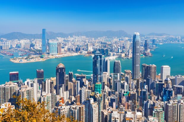 A clear view of Hong Kong skyline with skyscrapers and mountains in the background, 2K Desktop Wallpaper