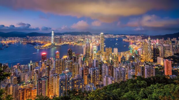 The Hong Kong skyline glows beautifully as night falls over the city and harbor, 2K Desktop Wallpaper