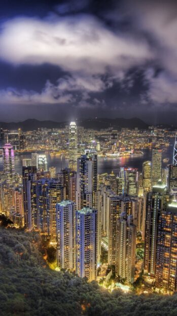 The Hong Kong skyline shows illuminated skyscrapers and a vibrant city by the water at night, HD Phone Wallpaper