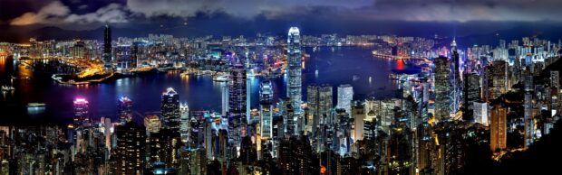 The Hong Kong skyline at night showcases illuminated skyscrapers and Victoria Harbour, 4K Desktop Wallpaper