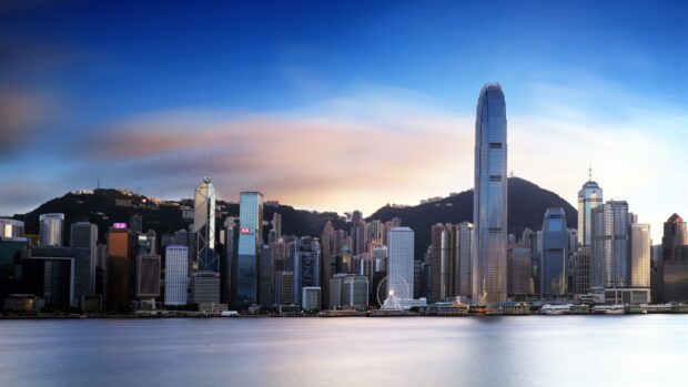 The Hong Kong skyline shows tall buildings and waterfront at sunset, HD Desktop Wallpaper