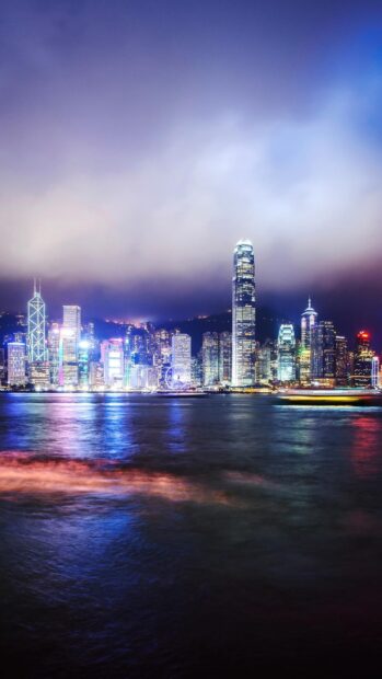 The Hong Kong skyline shines brightly with illuminated skyscrapers and reflections on the water, HD Phone Wallpaper