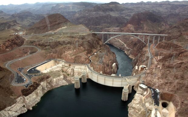 The Hoover Dam is captured with surrounding mountains and river in this aerial shot, HD Desktop Wallpaper