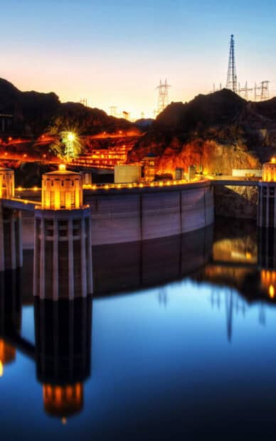 Hoover Dam is illuminated at dusk reflecting in calm water, HD Phone Wallpaper