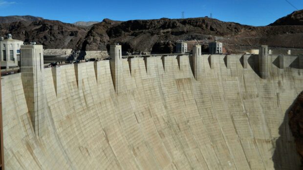 The Hoover Dam features a curved concrete structure with mountains in the background, 4K Desktop Wallpaper