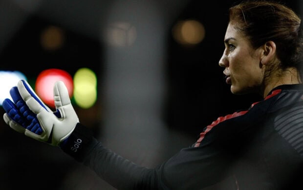 Hope Solo is preparing to defend a goal during a match, HD Desktop Wallpaper