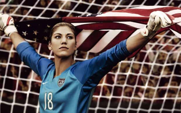 Hope Solo holds an American flag in front of a soccer goal net, 2K Desktop Wallpaper