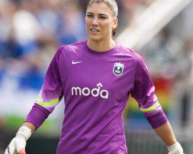 Hope Solo is focused during a soccer match wearing a purple Reign FC jersey, HD Desktop Wallpaper